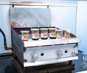 Testing equipment with a row of beakers holding different levels of liquids